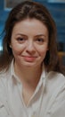 Portrait of young woman holding bowl of chips sitting on sofa