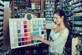 Portrait of young woman holding color sample palette Royalty Free Stock Photo