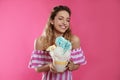 Portrait of young woman holding cotton candy dessert on background Royalty Free Stock Photo