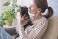 Portrait of a young woman holding a cute black ginger cat. The female hugs her cute kitty with long hair. close-up