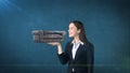 Portrait of young woman holding 3D leather sofa on the open hand palm, over isolated studio background. Business concept