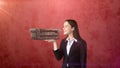 Portrait of young woman holding 3D leather sofa on the open hand palm, over isolated studio background. Business concept