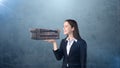 Portrait of young woman holding 3D leather sofa on the open hand palm, over isolated studio background. Business concept