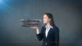 Portrait of young woman holding 3D leather sofa on the open hand palm, over isolated studio background. Business concept