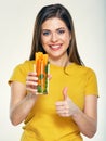 portrait of young woman holding glass with carrot. Royalty Free Stock Photo