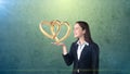 Portrait of young woman holding golden wedding rings on the open hand palm, isolated studio background. Business concept Royalty Free Stock Photo