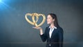 Portrait of young woman holding golden wedding rings on the open hand palm, isolated studio background. Business concept Royalty Free Stock Photo