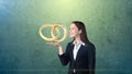 Portrait of young woman holding golden wedding rings on the open hand palm, isolated studio background. Business concept Royalty Free Stock Photo