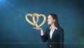 Portrait of young woman holding golden wedding rings on the open hand palm, isolated studio background. Business concept Royalty Free Stock Photo