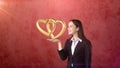 Portrait of young woman holding golden wedding rings on the open hand palm, isolated studio background. Business concept Royalty Free Stock Photo