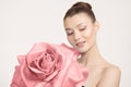 Portrait Young woman holding a rose in her hands. Pink big flower. Clean skin concept Royalty Free Stock Photo