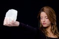 Portrait of young woman holding stone