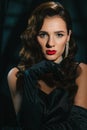 Portrait of a young woman in Hollywood retro noir style. A beautiful brunette girl with a hairstyle and makeup Royalty Free Stock Photo