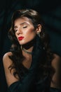 Portrait of a young woman in Hollywood retro noir style. A beautiful brunette girl with a hairstyle and makeup Royalty Free Stock Photo