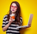 Portrait of a young woman with laptop and cup of coffee Royalty Free Stock Photo