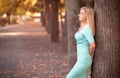 Portrait of young woman leaning against a tree Royalty Free Stock Photo