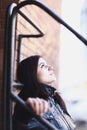 Portrait of a young woman leaning against a wall of a city building Royalty Free Stock Photo