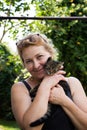 Portrait of young woman with little cat