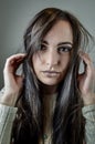 Portrait of a young woman with long brown hair and a captivating and seductive gaze Royalty Free Stock Photo
