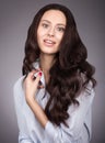 Portrait of a young woman with long luxurious hair hair. Makeup and gentle smile