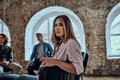 Portrait of young woman look at camera sits in a circle at group psychological counseling, relieved female posing for picture