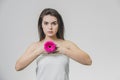 Portrait of beautiful young woman looking at camera with a pink flower. Isolated on white background. Skin care and Royalty Free Stock Photo