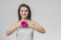 Portrait of beautiful young woman looking at camera with a pink flower. Isolated on white background. Skin care and Royalty Free Stock Photo