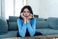 Portrait of a young woman looking scared and shocked watching TV. Human expressions and emotions Royalty Free Stock Photo