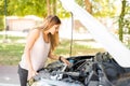 Woman looking at the engine of her broken car Royalty Free Stock Photo