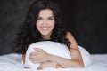 Portrait of a young woman lying in bed. Royalty Free Stock Photo