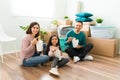Portrait of a young woman, man and girl eating fast food while unpacking Royalty Free Stock Photo
