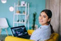 Portrait of young woman mobile developer with laptop, writes program code on a computer, programmer work