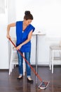 Portrait Of Young Woman Mopping Floor At Home . Cleaning Sevice