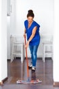 Portrait Of Young Woman Mopping Floor At Home . Cleaning Sevice Royalty Free Stock Photo