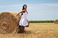 Portrait of a young woman next to haystack Royalty Free Stock Photo