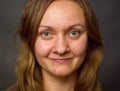 Portrait of young woman, no make up, brown dark hair, no retouch making expressions.