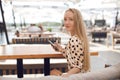 Portrait of a young woman outdoor in cafe with mobile phone Royalty Free Stock Photo