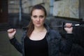 Portrait of young woman outdoors with epee