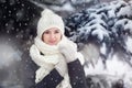 Portrait of a young woman outdoors under snovfall.