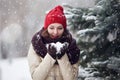 Portrait of a young woman outdoors under snovfall.