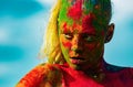 Portrait of young woman with paint make-up. Color face with colorful holi splash. Concept for Indian festival Holi. Royalty Free Stock Photo