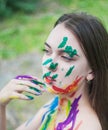 Portrait of young woman with paints on the face Royalty Free Stock Photo