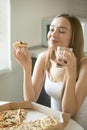 Portrait of a young woman with pizza in her hand Royalty Free Stock Photo