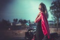 Portrait of young woman posing front classical motorbike