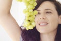 Portrait of young woman posing with grapes. Royalty Free Stock Photo
