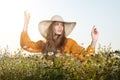 Portrait of young woman posing in a hat. Blooming field of daisies Royalty Free Stock Photo