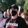 Portrait of young woman in protective mask in the park