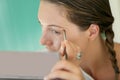 Portrait of a young woman putting makeup on Royalty Free Stock Photo