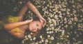 Portrait of young  woman  lying down amid flowers Royalty Free Stock Photo