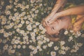 Portrait of young  woman with radiant clean skin lying down amid flowers Royalty Free Stock Photo